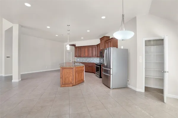 a kitchen with refrigerator and microwave