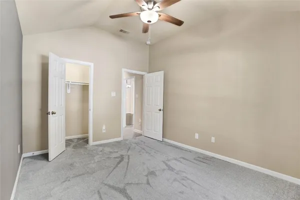an empty room with kitchen and a sink