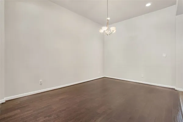 an empty room with a view of a kitchen