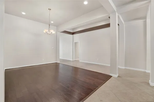 an empty room with wooden floor and door