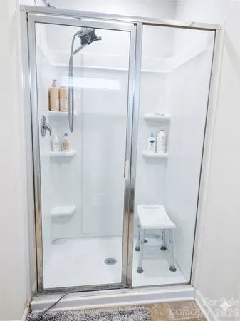 a bathroom with a glass shower door