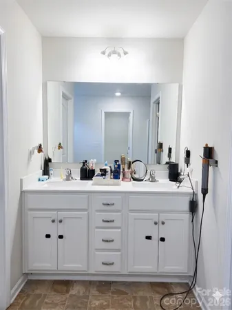 a bathroom with a double vanity sink mirror and