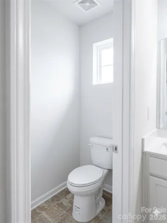a white toilet sitting next to a bathroom sink