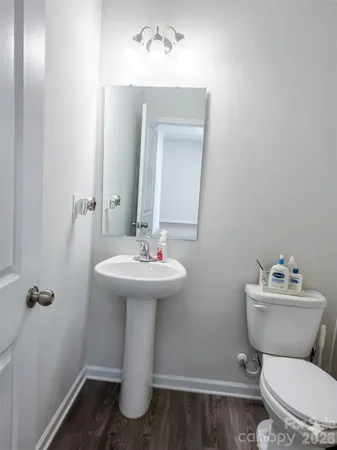 a bathroom with a sink mirror toilet and a mirror