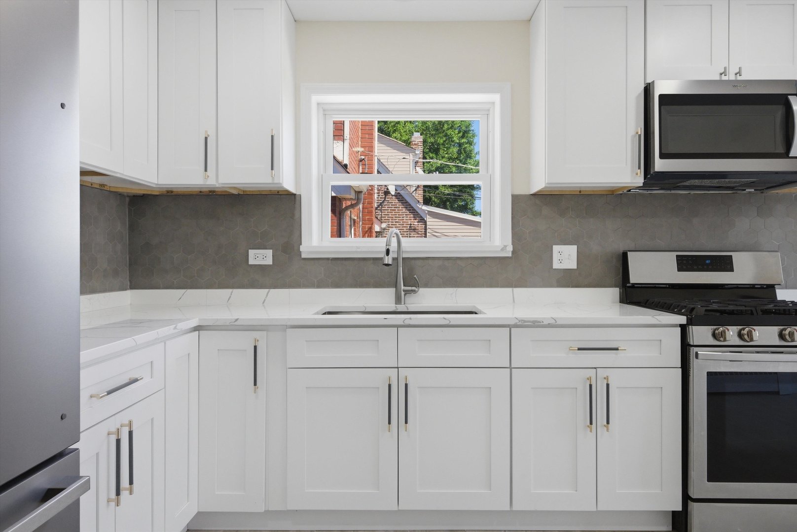 3907 West Marquette Road Chicago, IL 60629 - Photo 11 of 32 a kitchen with white cabinets and window
