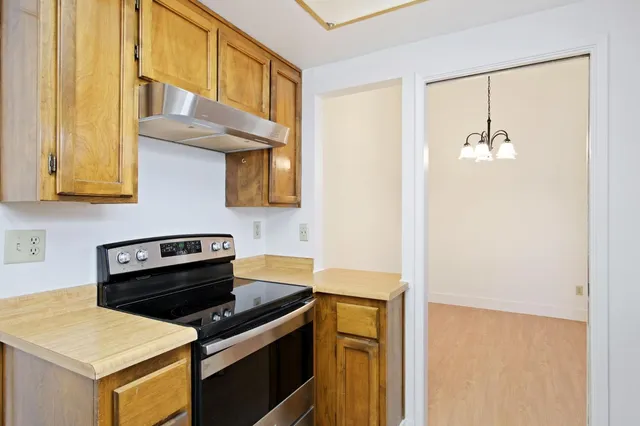 a kitchen with stainless steel appliances granite countertop a stove and a refrigerator