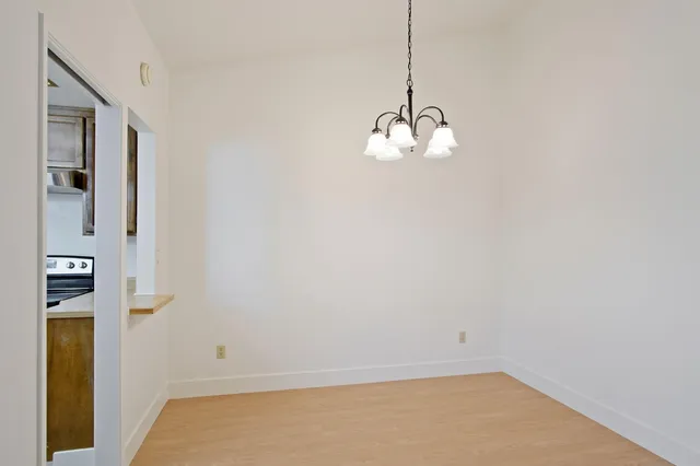 a view of a room with a sink and cabinets