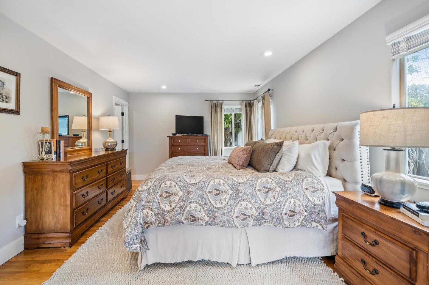 26571 Oliver Road Carmel, CA 93923 - Photo 24 of 63 a spacious bedroom with a bed and wooden floor