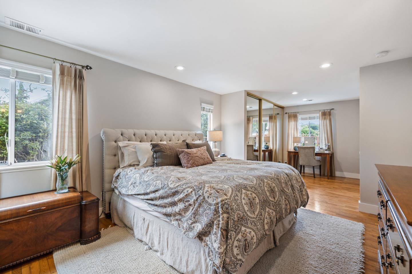 26571 Oliver Road Carmel, CA 93923 - Photo 25 of 63 a large bedroom with a bed and wooden floor