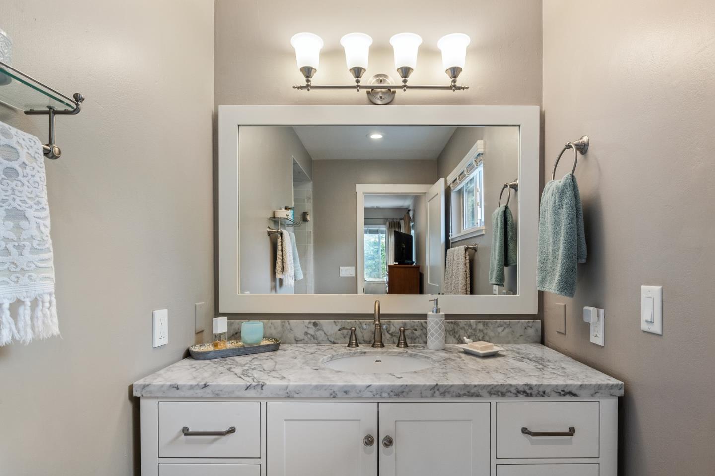 26571 Oliver Road Carmel, CA 93923 - Photo 26 of 63 a bathroom with a granite countertop sink and a mirror