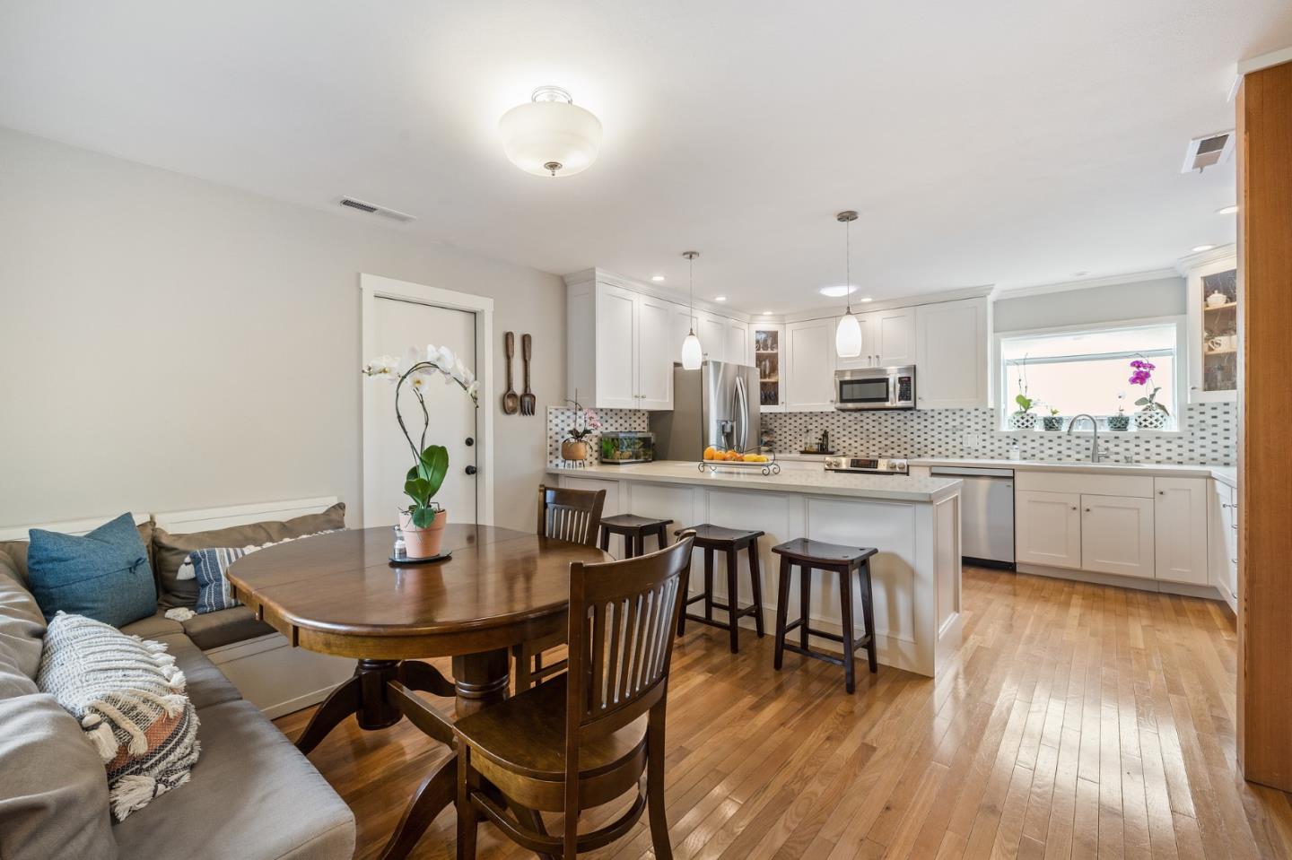 26571 Oliver Road Carmel, CA 93923 - Photo 7 of 63 a kitchen with a dining table chairs and white cabinets