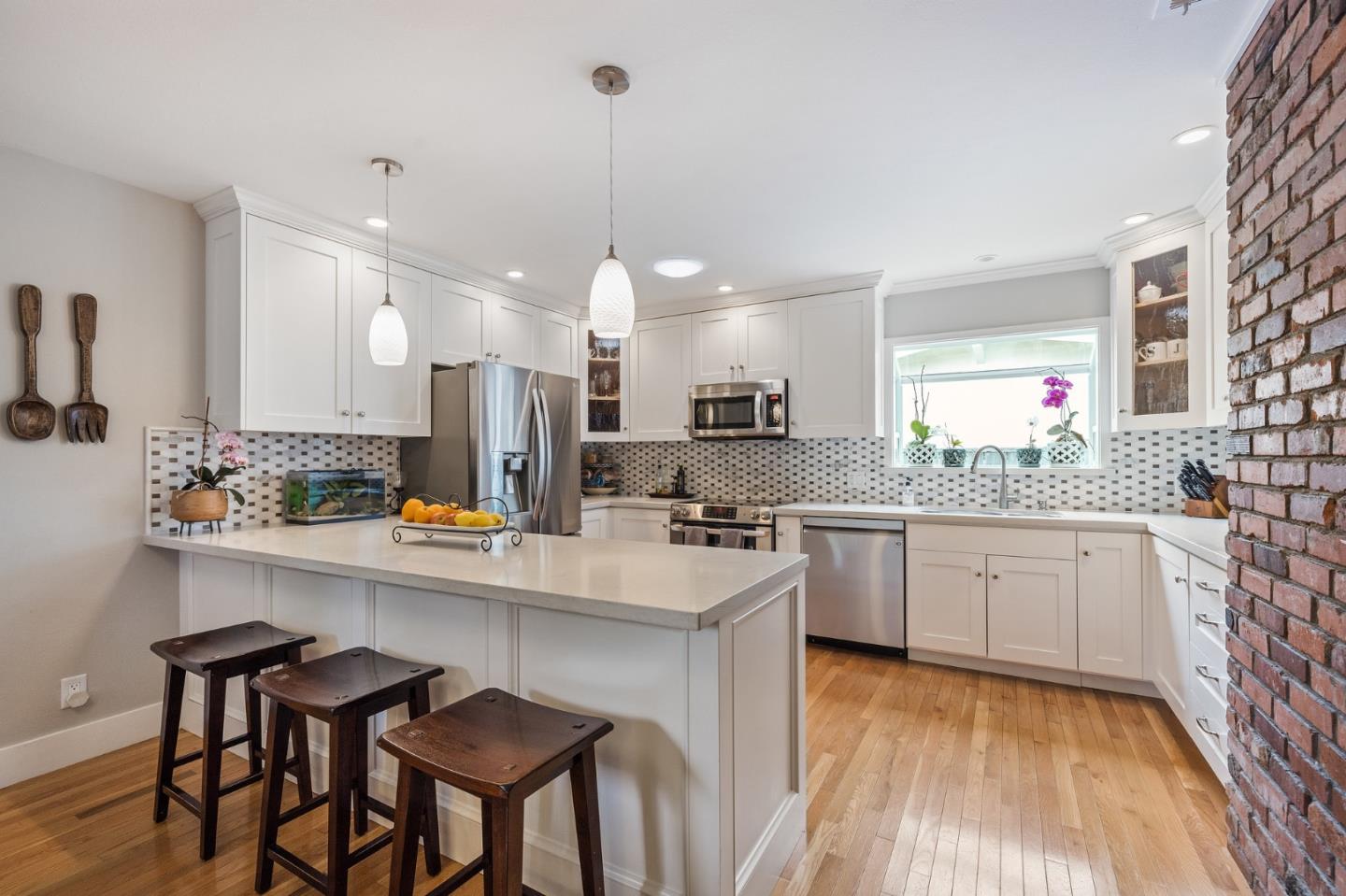26571 Oliver Road Carmel, CA 93923 - Photo 8 of 63 a kitchen with kitchen island granite countertop a sink a center island and cabinets