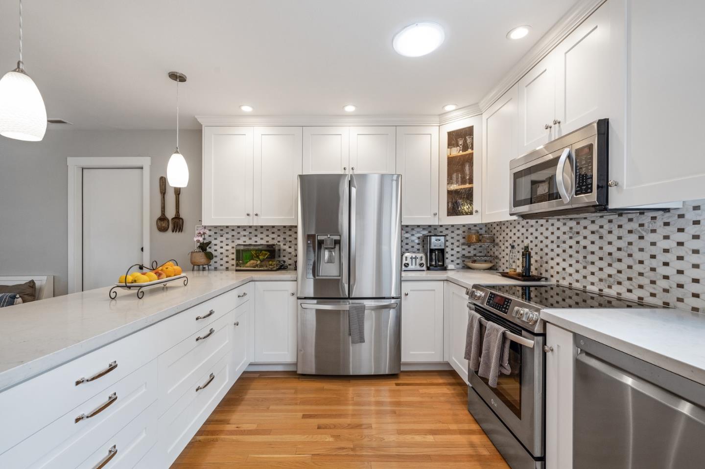 26571 Oliver Road Carmel, CA 93923 - Photo 9 of 63 a kitchen with granite countertop a refrigerator and a stove