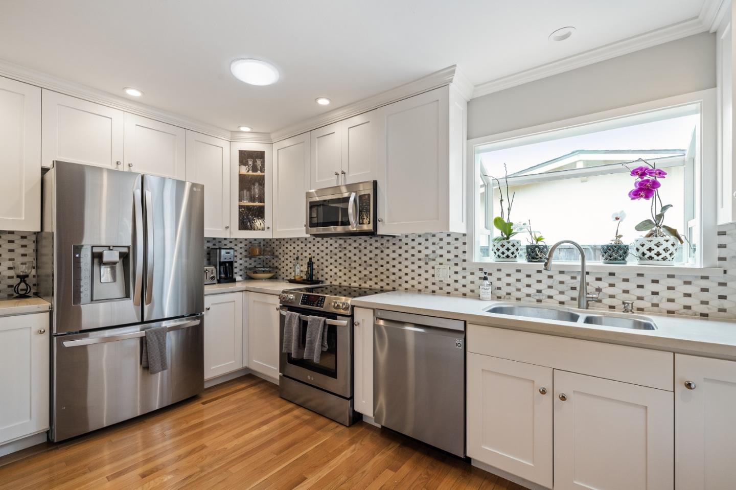 26571 Oliver Road Carmel, CA 93923 - Photo 10 of 63 a kitchen with granite countertop stainless steel appliances and wooden floor