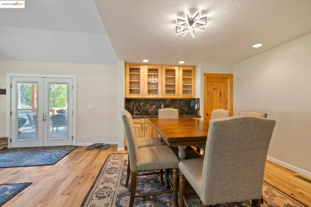 a kitchen with stainless steel appliances granite countertop a sink refrigerator and cabinets