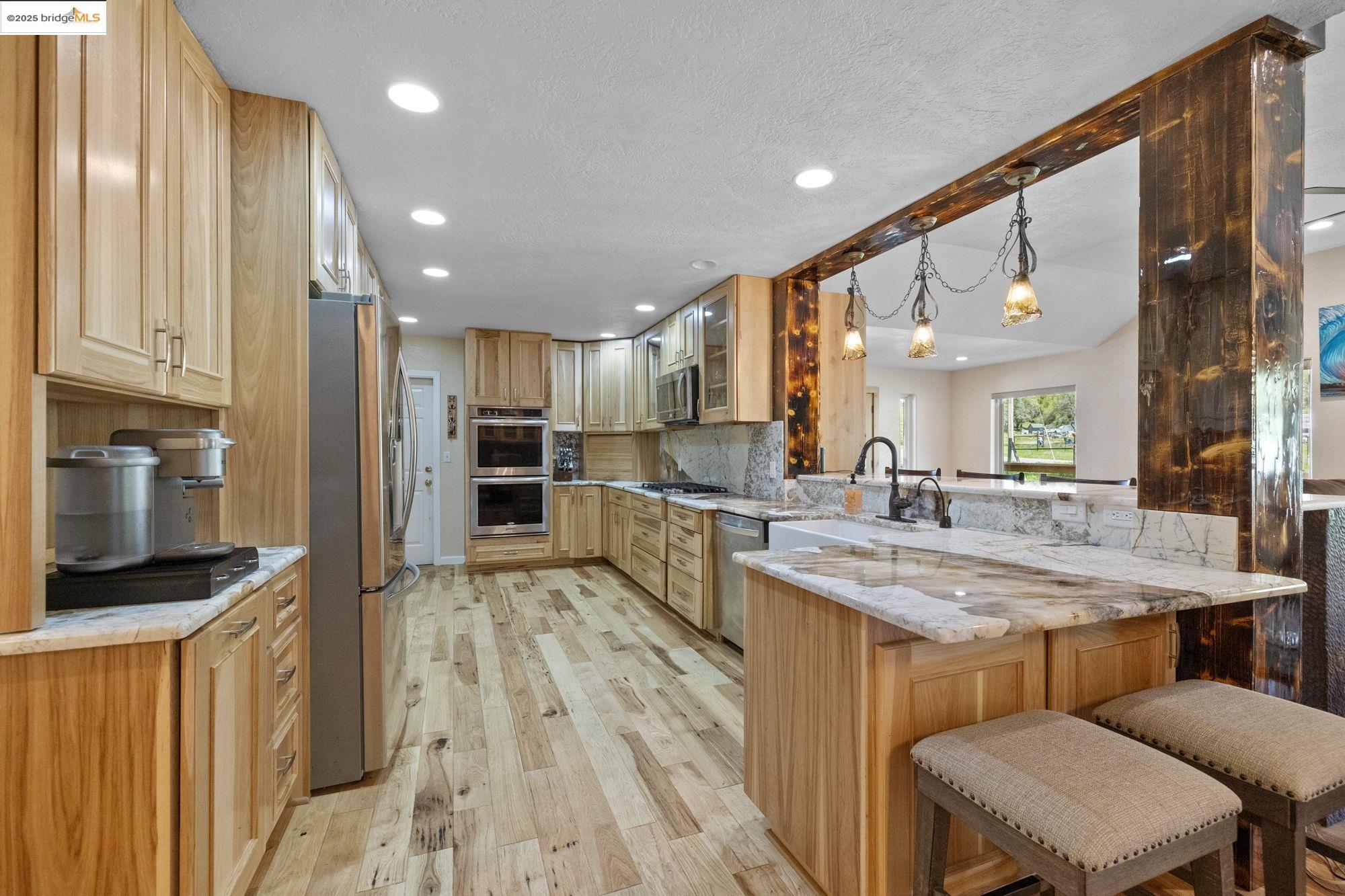 18060 Rob-Ric Road Sonora, CA 95370 - Photo 14 of 52 a kitchen with stainless steel appliances granite countertop a sink refrigerator and cabinets