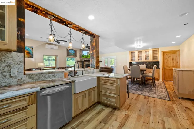 a kitchen with stainless steel appliances a refrigerator and a stove top oven