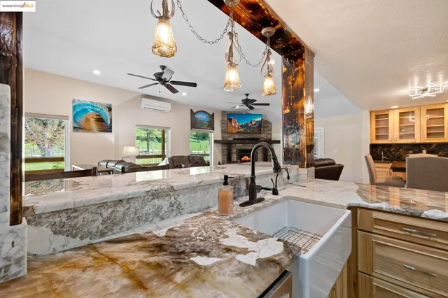 a living room with furniture ceiling fan and a rug