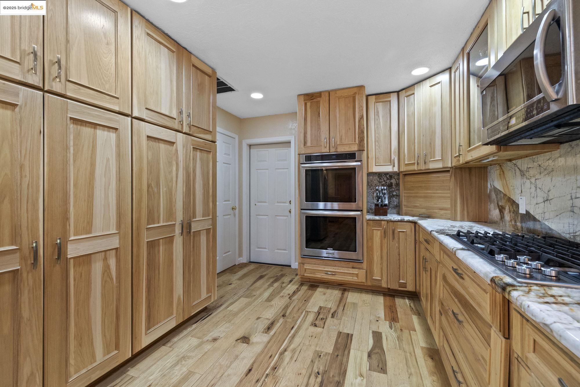 18060 Rob-Ric Road Sonora, CA 95370 - Photo 17 of 52 a kitchen with stainless steel appliances a refrigerator and a stove top oven