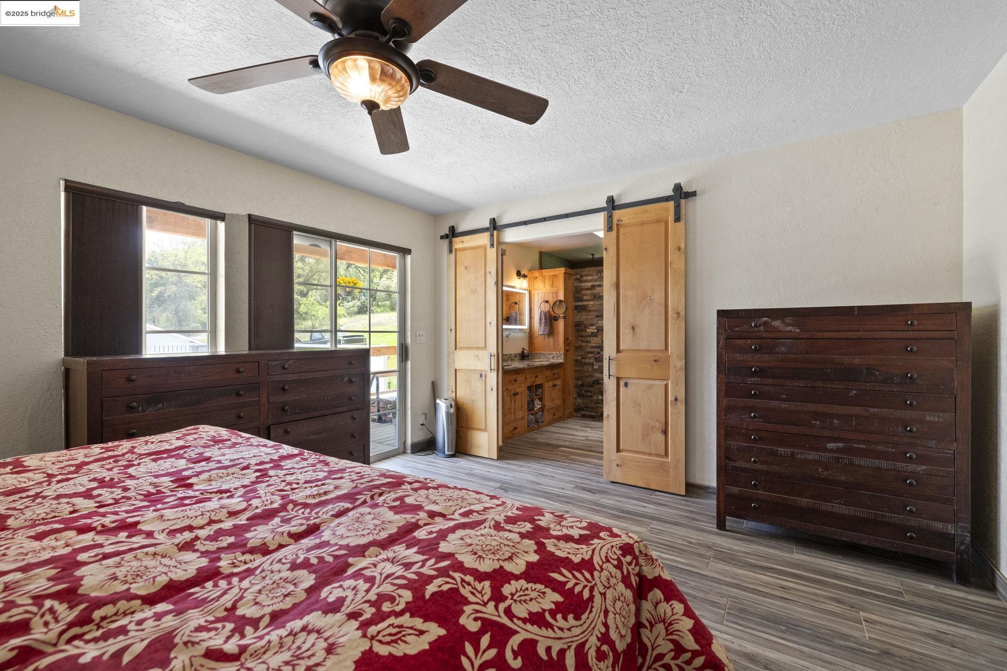 18060 Rob-Ric Road Sonora, CA 95370 - Photo 21 of 52 a bedroom with a bed and wooden floor
