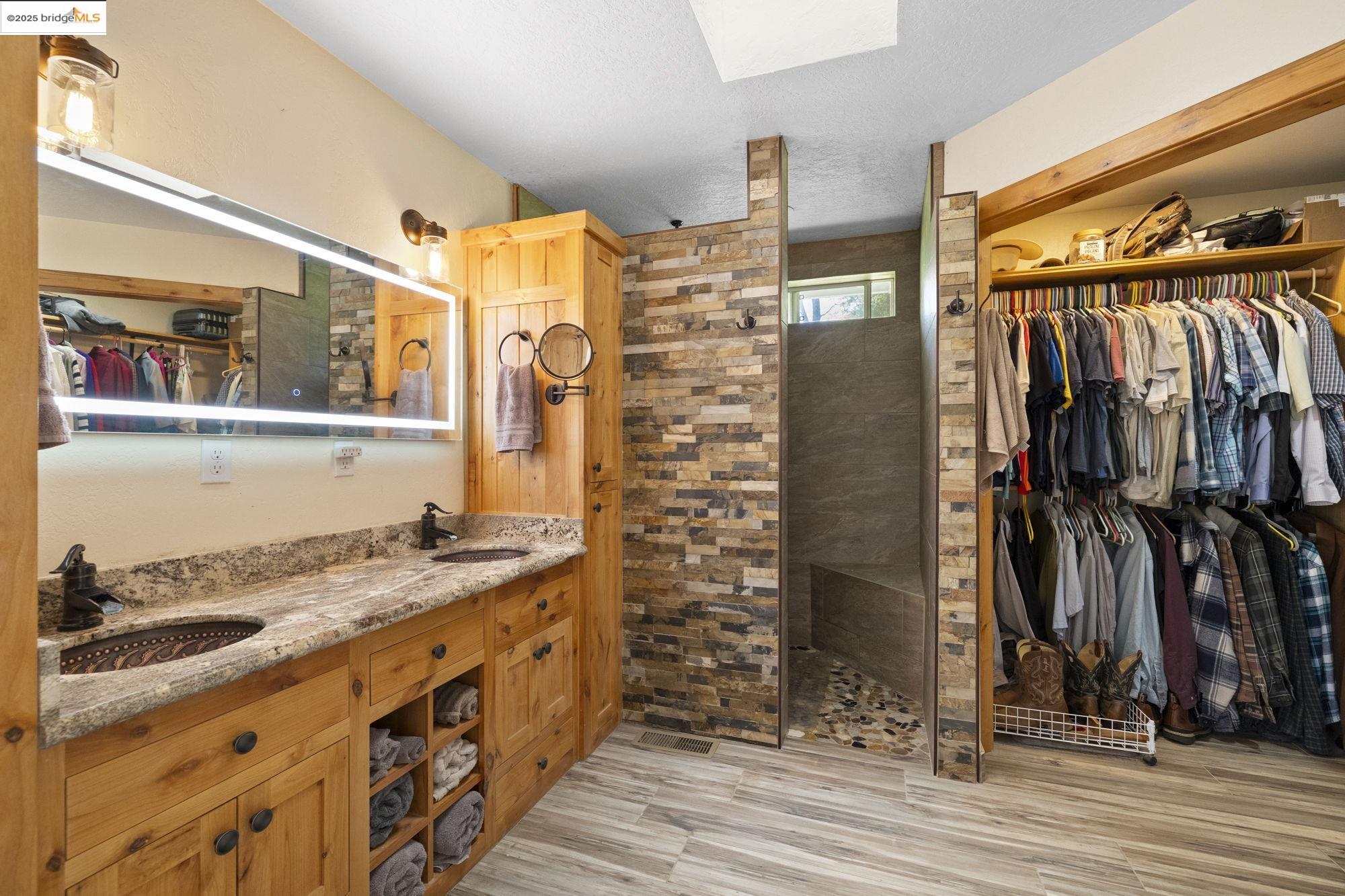 18060 Rob-Ric Road Sonora, CA 95370 - Photo 22 of 52 a bathroom with a granite countertop sink and a mirror