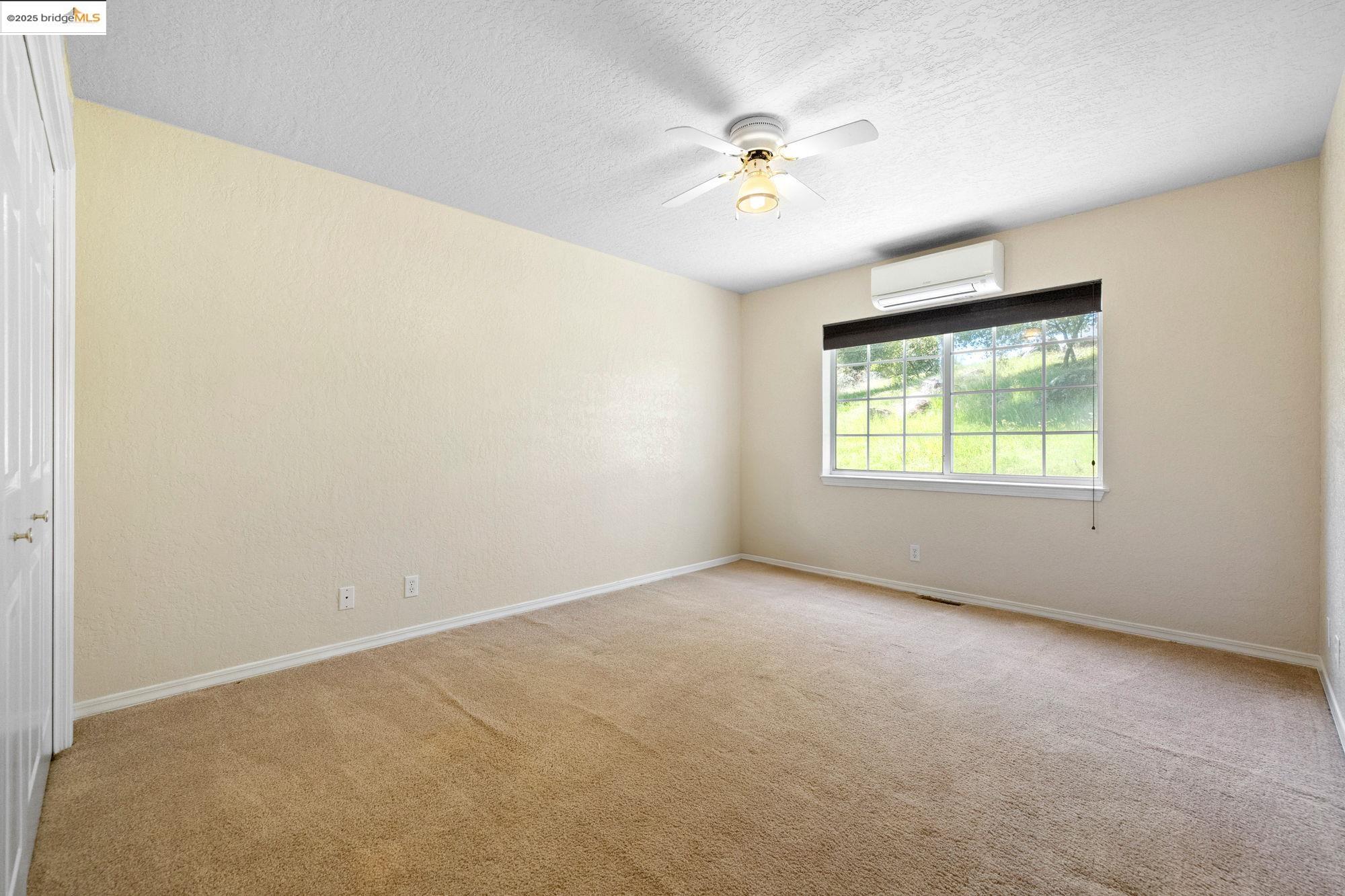 18060 Rob-Ric Road Sonora, CA 95370 - Photo 25 of 52 an empty room with windows and fan