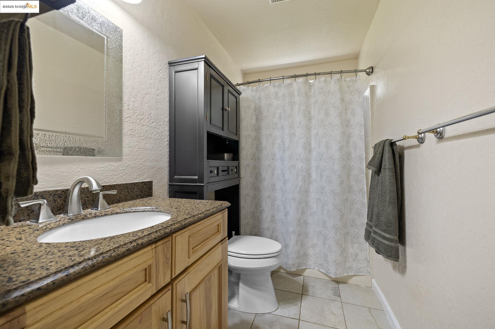 18060 Rob-Ric Road Sonora, CA 95370 - Photo 26 of 52 a bathroom with a granite countertop sink toilet and shower
