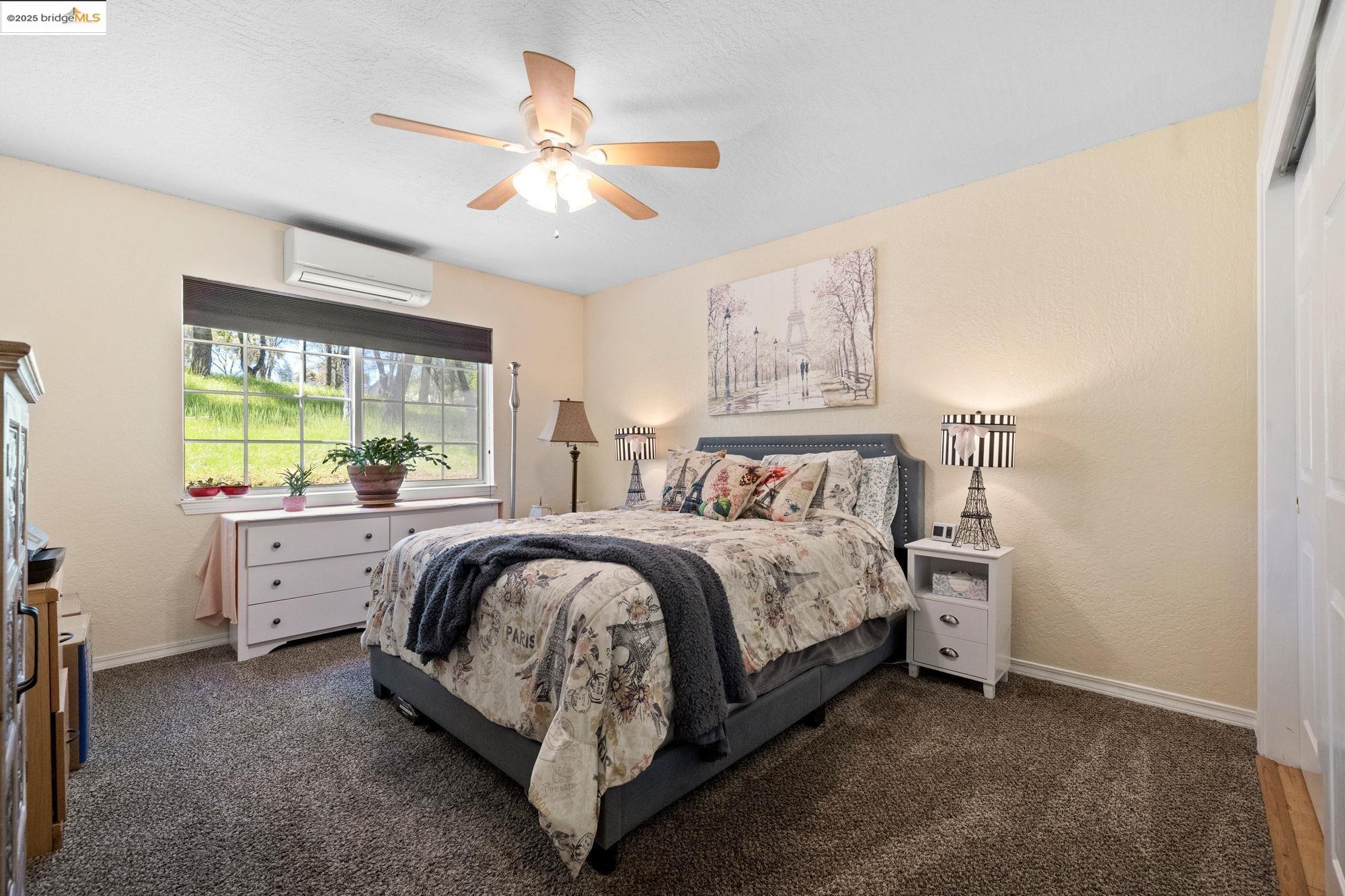 18060 Rob-Ric Road Sonora, CA 95370 - Photo 27 of 52 a spacious bedroom with a large bed and a chandelier