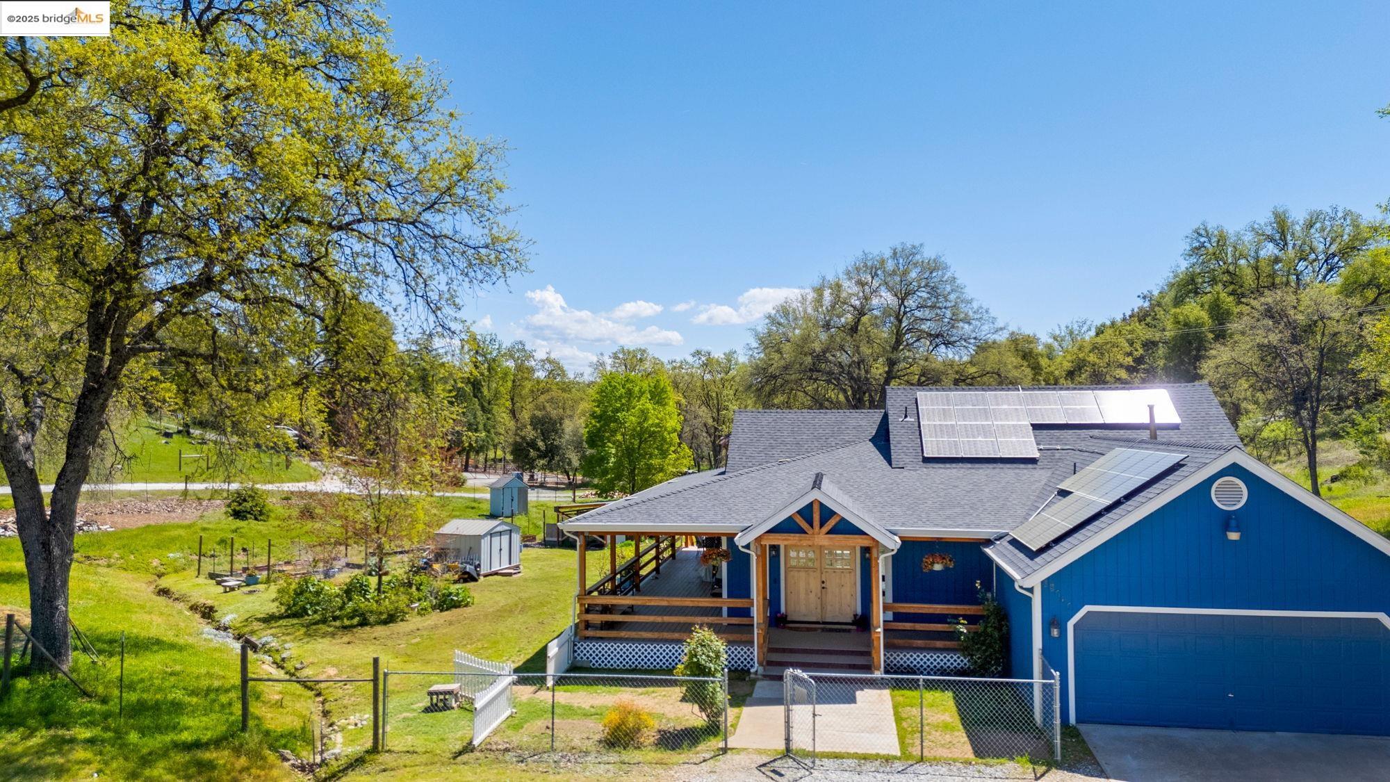 18060 Rob-Ric Road Sonora, CA 95370 - Photo 3 of 52 a view of a patio with table and chairs potted plants and large tree