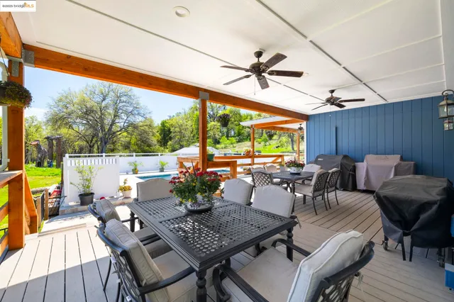 a view of a balcony with chairs and wooden floor