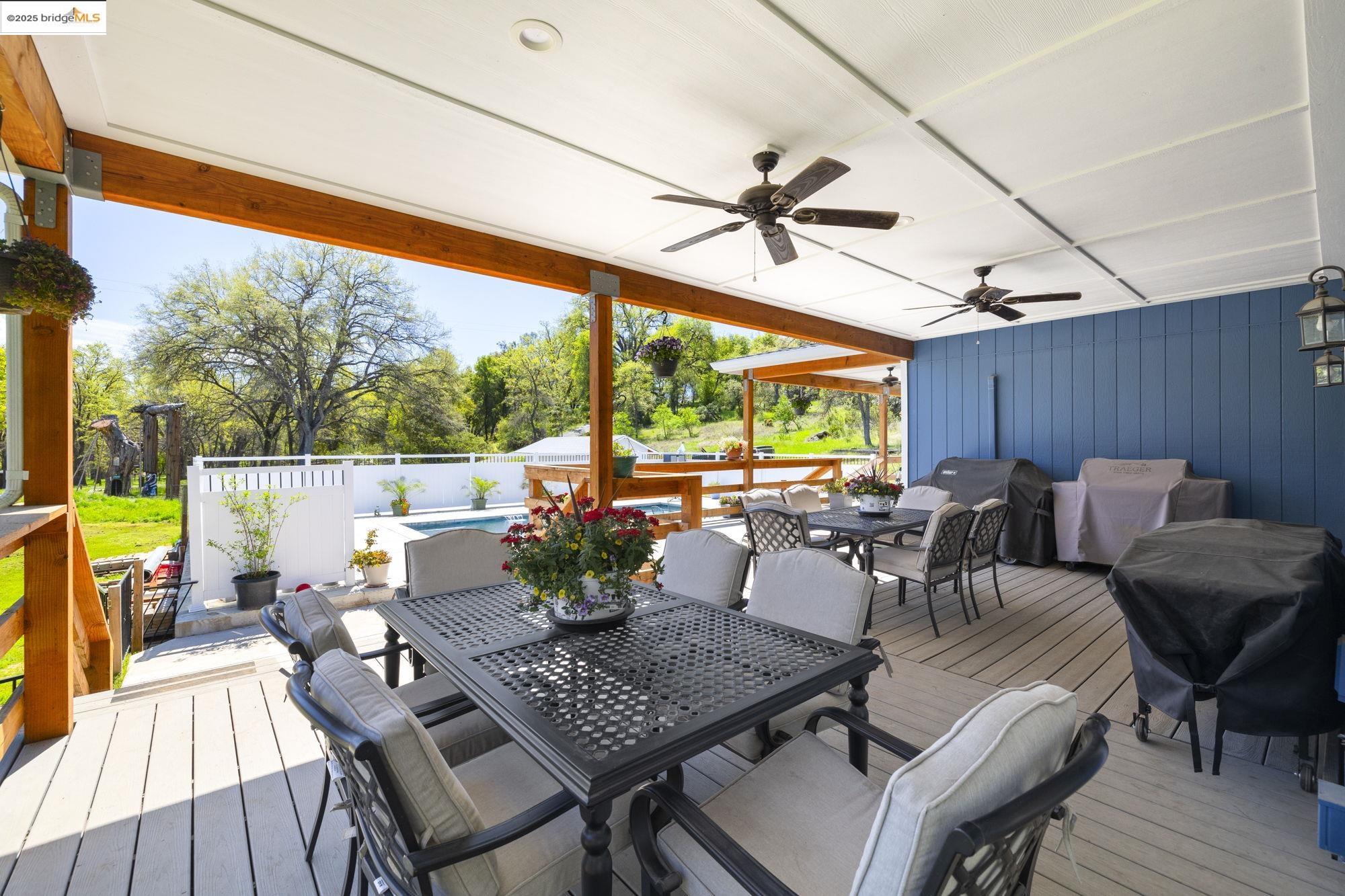 18060 Rob-Ric Road Sonora, CA 95370 - Photo 34 of 52 a view of a patio with a dining table and chairs