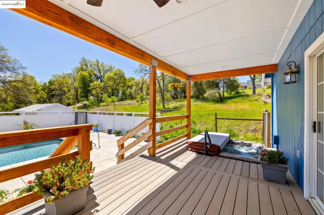 a view of a house with swimming pool and sitting area