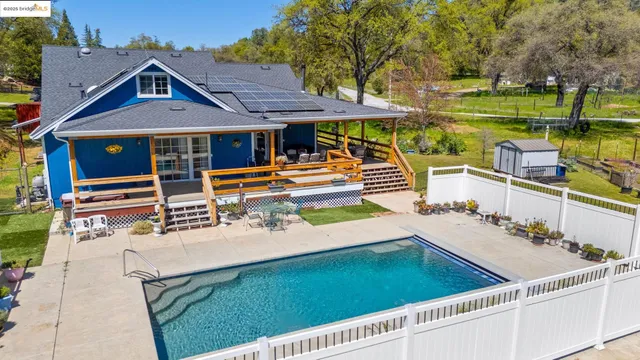 an aerial view of a house with a garden and lake view