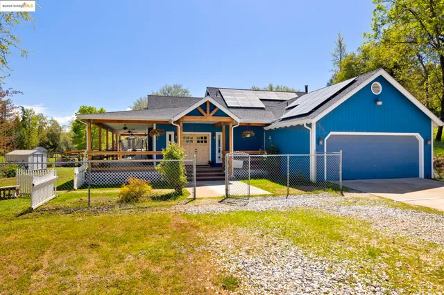 a view of a bedroom with wooden floor and windows