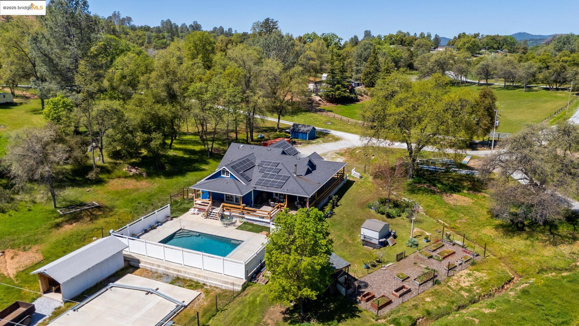 18060 Rob-Ric Road Sonora, CA 95370 - Photo 42 of 52 an aerial view of a house with a garden and lake view