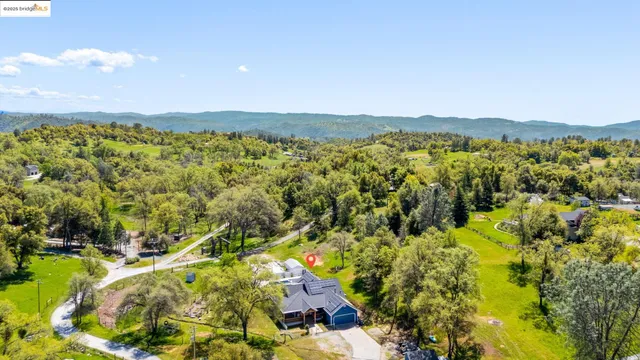 an aerial view of residential houses with outdoor space and swimming pool