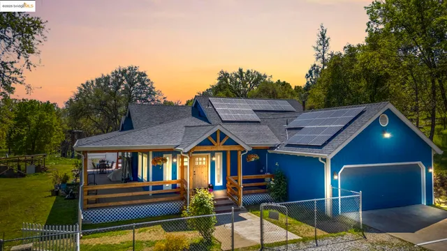 a view of a house with swimming pool and sitting area