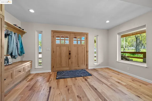 a room with lots of wooden furniture and a ceiling fan