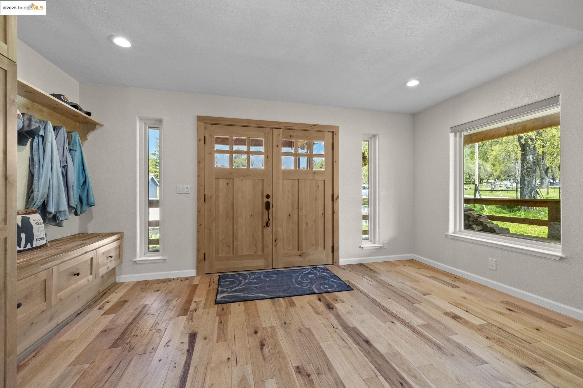 18060 Rob-Ric Road Sonora, CA 95370 - Photo 6 of 52 a view of a bedroom with wooden floor and windows