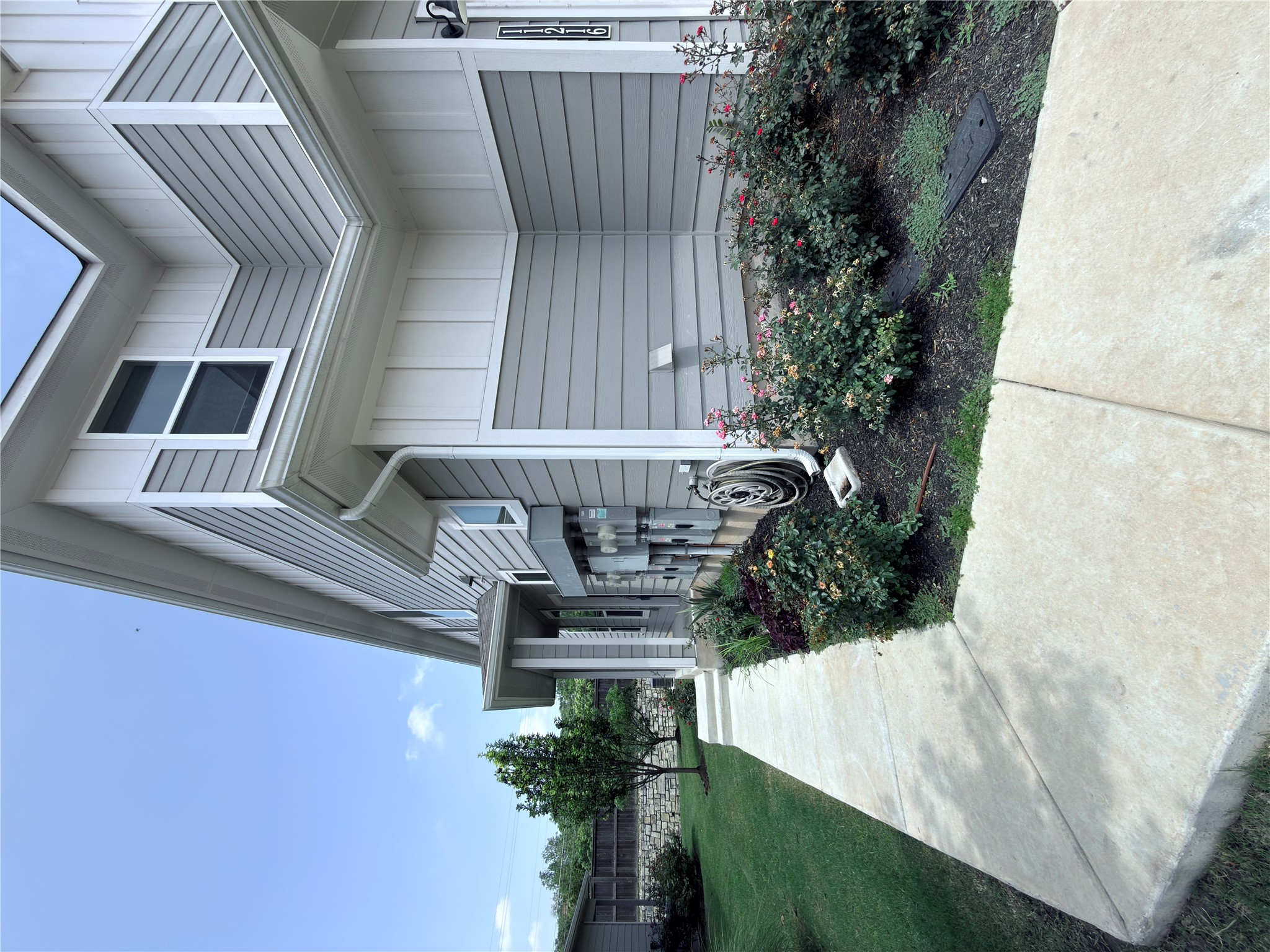 11216 Gadsen Lane Austin, TX 78754 - Photo 4 of 36 A well-maintained concrete path leads to this charming residence with landscaped garden beds.
