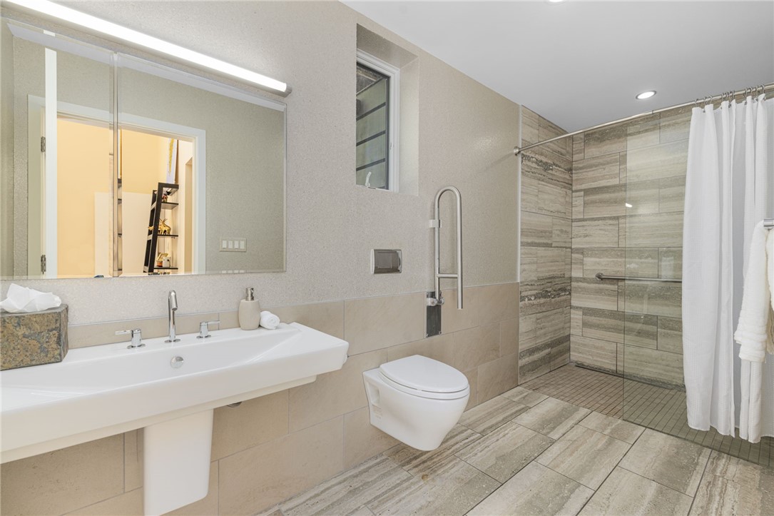 621 East Shore Road Jamestown, RI 02835 - Photo 37 of 50 Back inside, this primary en suite bath is spacious with Walker Zanger travertine tile.