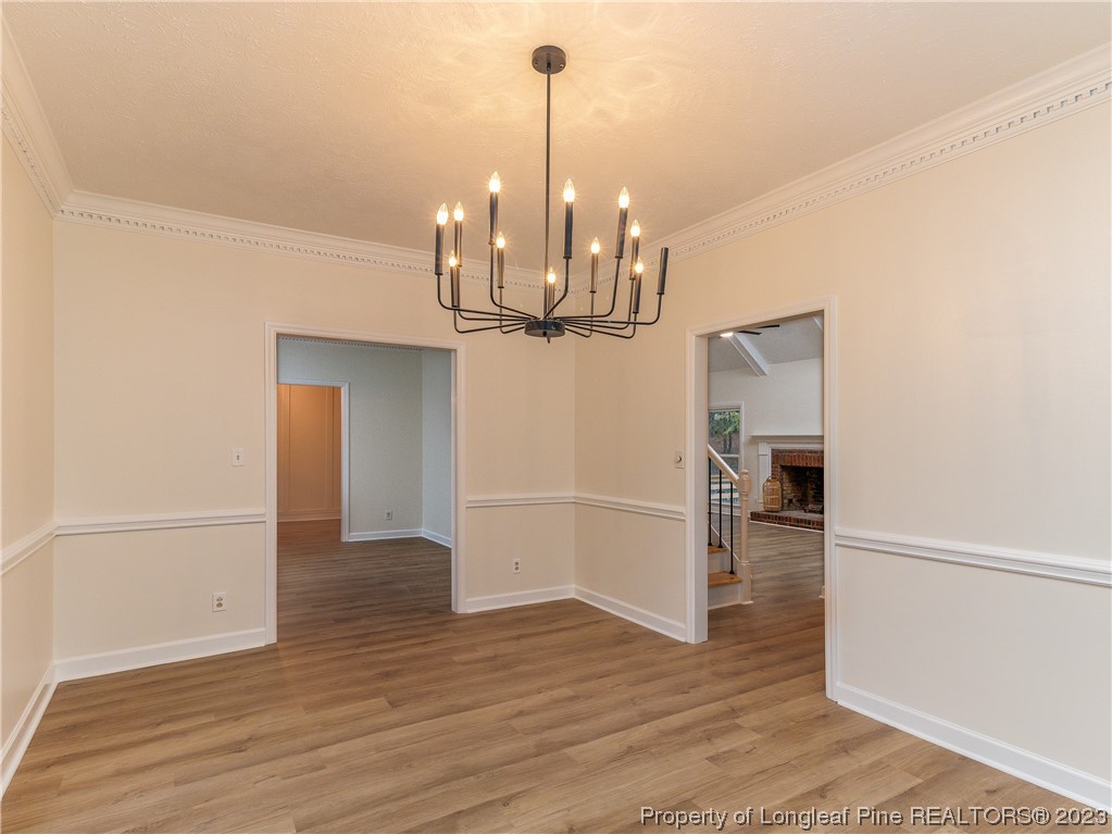 6915 South Staff Road Fayetteville, NC 28306 - Photo 12 of 23 a view of a room with wooden floor and chandelier