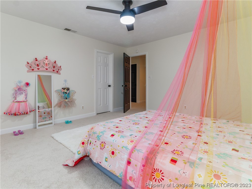 6915 South Staff Road Fayetteville, NC 28306 - Photo 19 of 23 a bedroom with a bed and a dresser