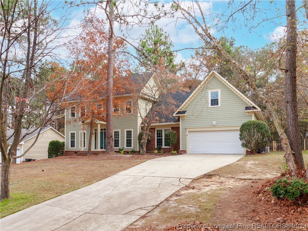 6915 South Staff Road Fayetteville, NC 28306 - Photo 2 of 23 a view of a white house with a large tree