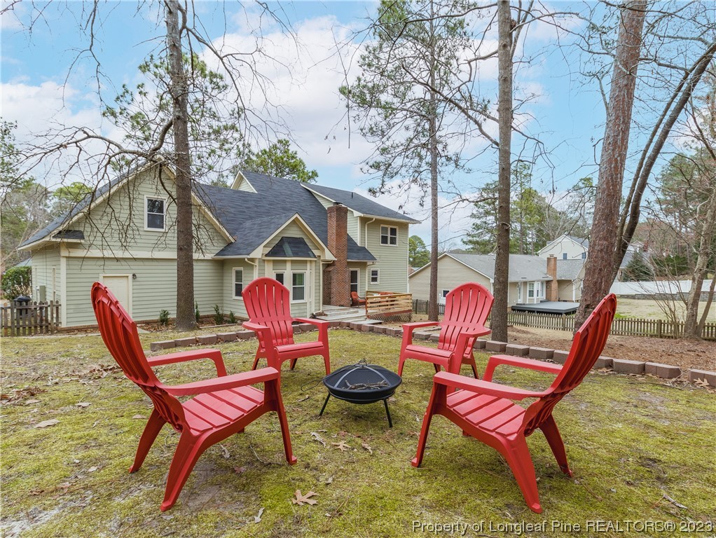 6915 South Staff Road Fayetteville, NC 28306 - Photo 23 of 23 a wooden bench sitting in backyard of a house