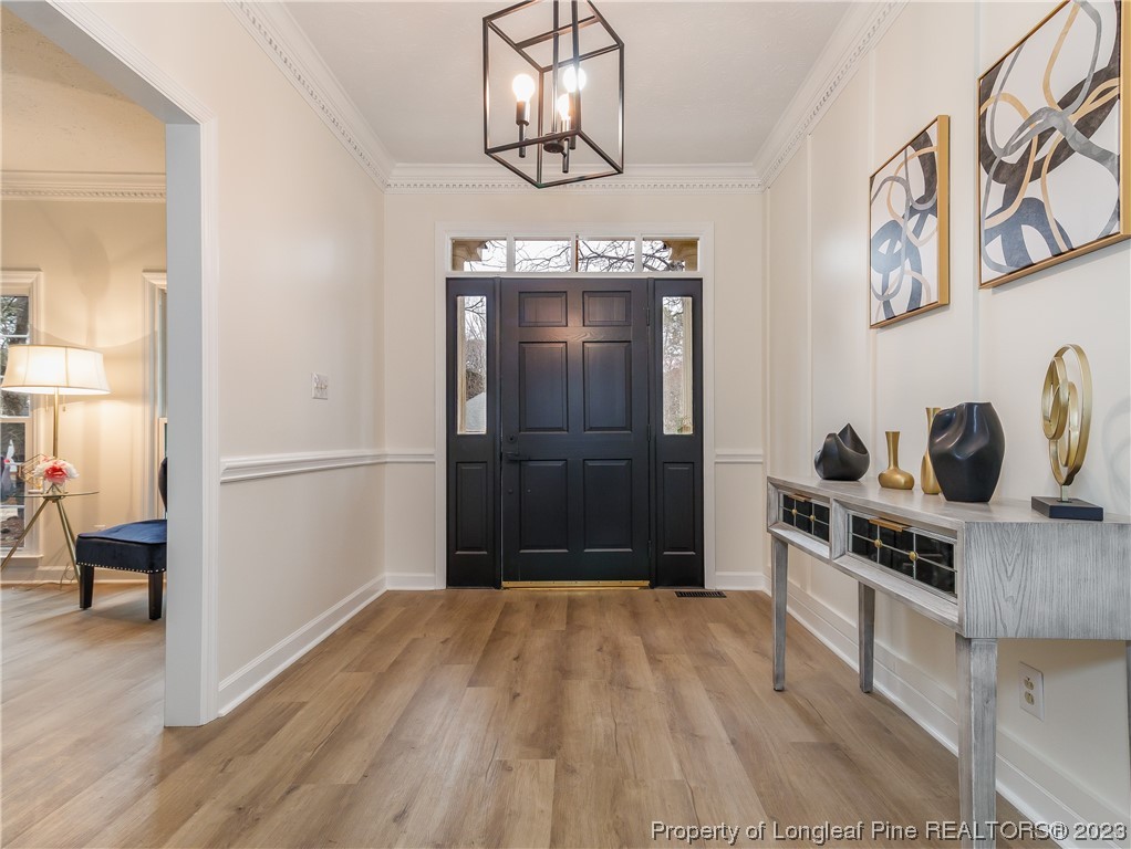 6915 South Staff Road Fayetteville, NC 28306 - Photo 4 of 23 a kitchen with a refrigerator and cabinets