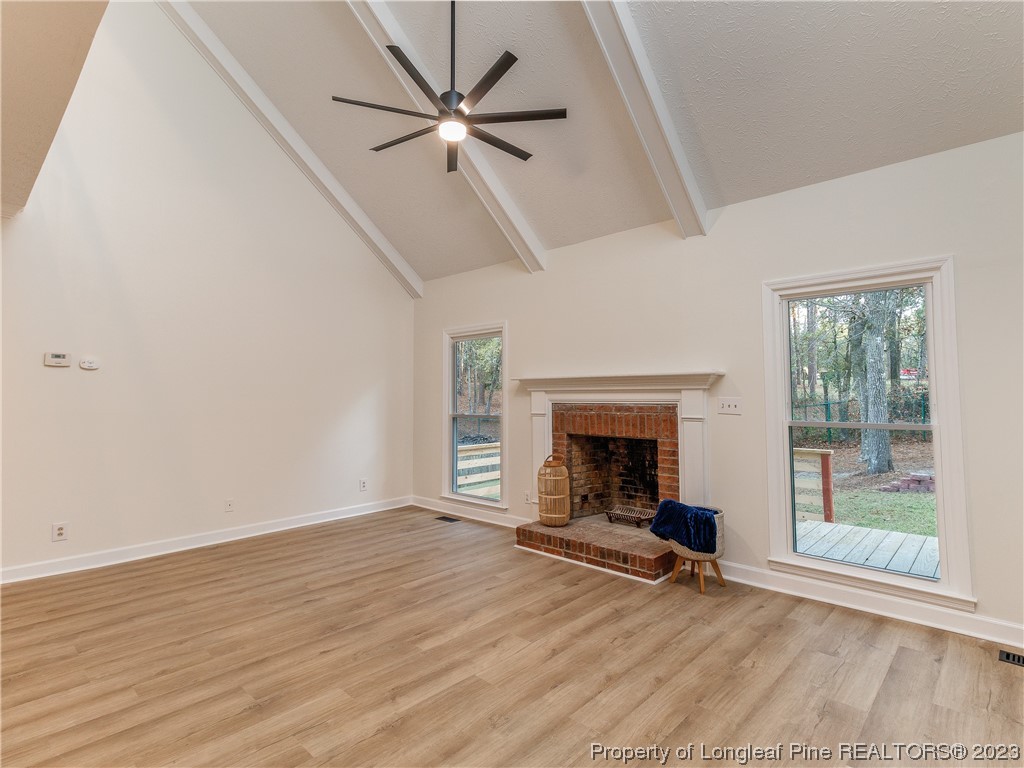 6915 South Staff Road Fayetteville, NC 28306 - Photo 8 of 23 a view of an empty room with wooden floor fireplace and a window