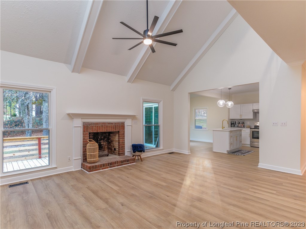 6915 South Staff Road Fayetteville, NC 28306 - Photo 9 of 23 a view of an empty room with a fireplace and a window