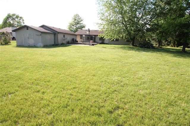 4423 Waltham Road Roscoe, IL 61073 - Photo 8 of 22 a view of a house with a yard and a large tree