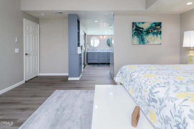 a bedroom with a large bed and a chandelier